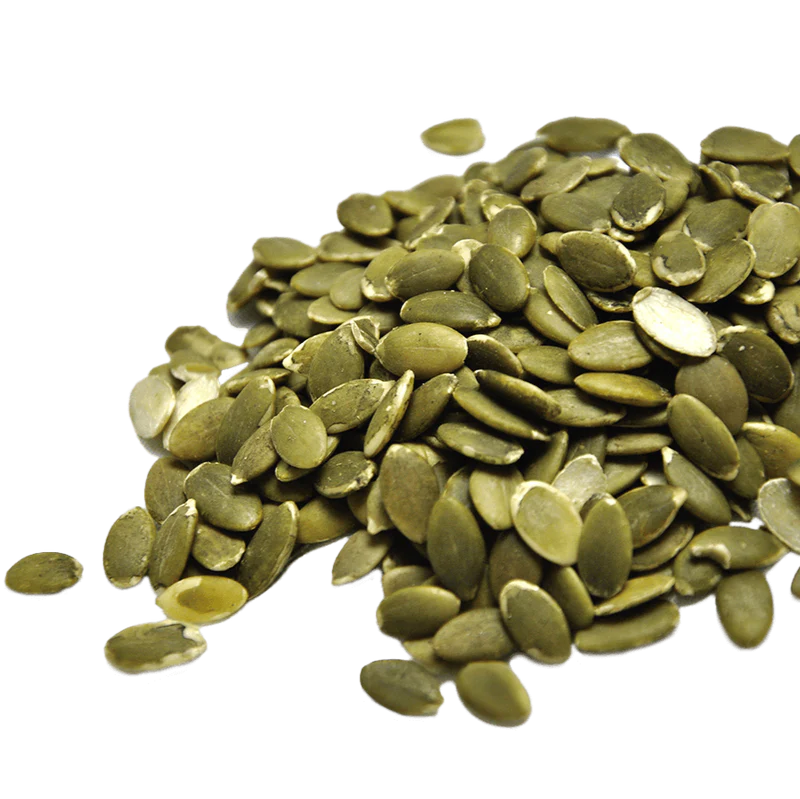 A pile of green pumpkin seeds on a white background.