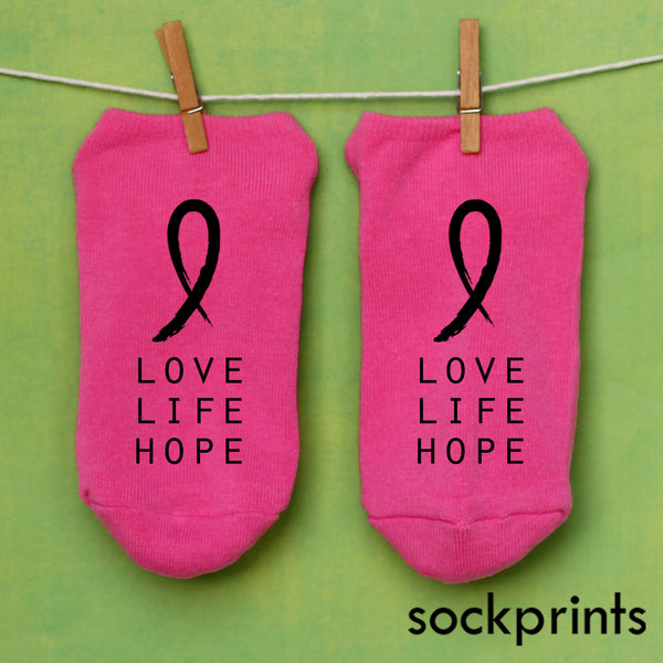 This is an image of a pair of pink Breast Cancer Awareness socks with the pink ribbon symbol and the words "Love Life Hope."