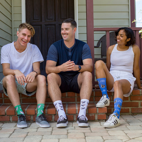 This is an image of three people wearing full print photo pet socks.