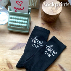 This is an image of Valentine's Day themed socks with custom initials.