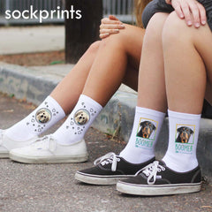 This is an image of two people wearing two pairs of custom printed pet socks.