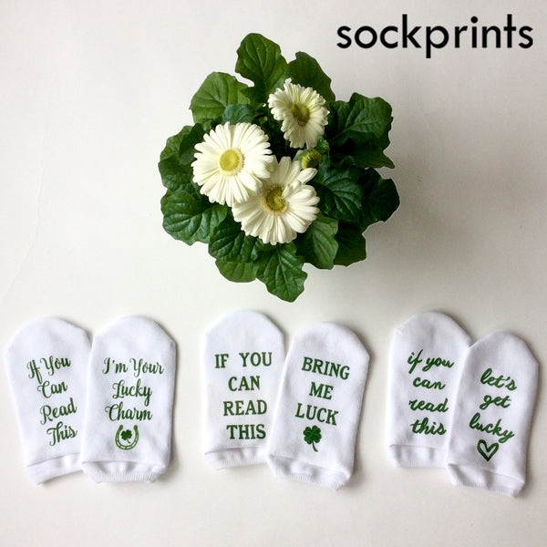This is an image of an assortment of St. Patrick's Day themed custom printed socks.
