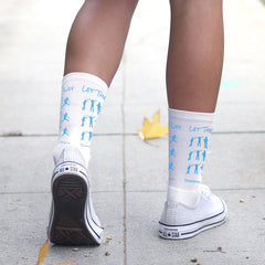 This is an image of Let Them Play white crew socks.