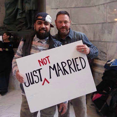 Same-sex-couple-holding-up-a-just-not-married-sign
