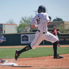 This is an image of a baseball base runner wearing Custom Printed Large Baseball and Softball Knee High Socks.
