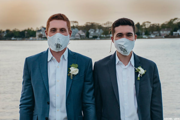 This is an image of a couple wearing custom printed Mr. and Mr. wedding face masks.