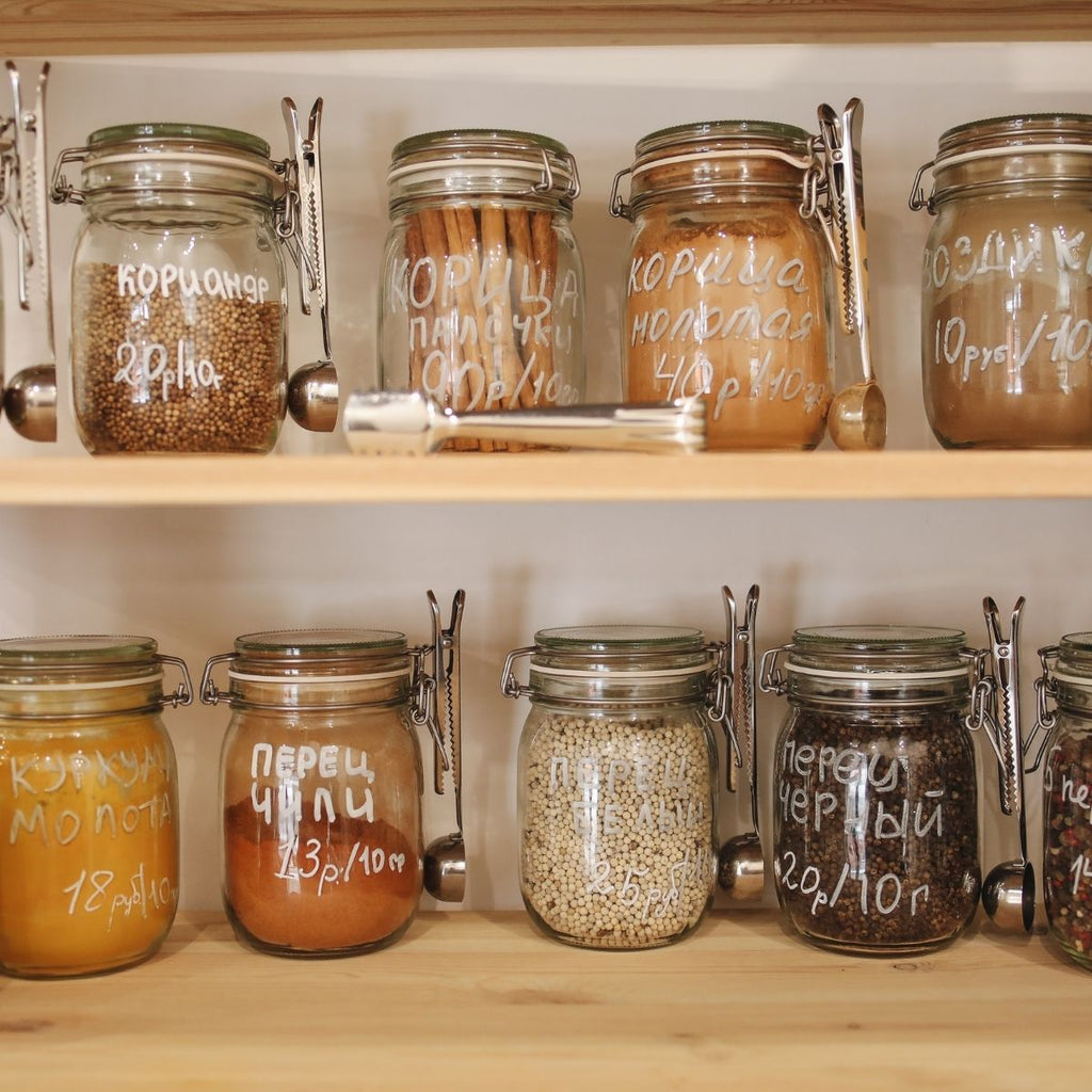 Glass jars on a wooden shelf for 8 Ways to reduce your use of single-use plastic blog