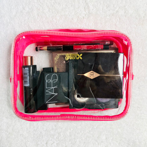 clear makeup bag neatly containing cosmetics