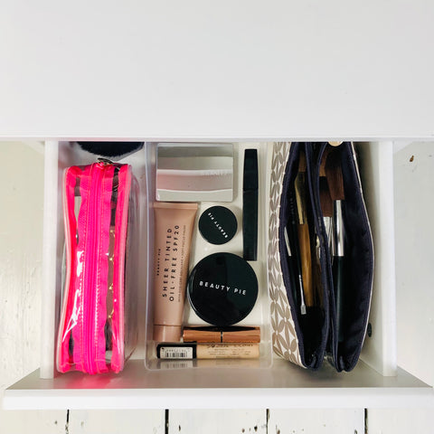 Perfectly organised makeup drawer using folding makeup bag and a clear makeup bag