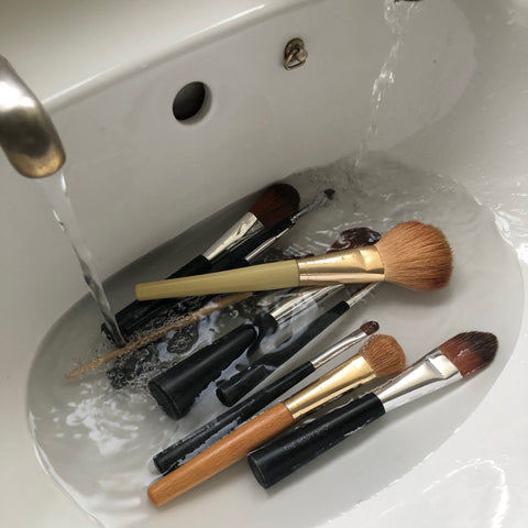 makeup brushes being washed ready to go back into a clean makeup bag