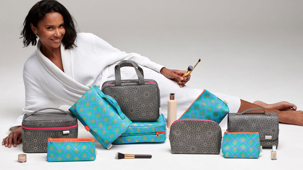model with collection of wash bags and makeup bags