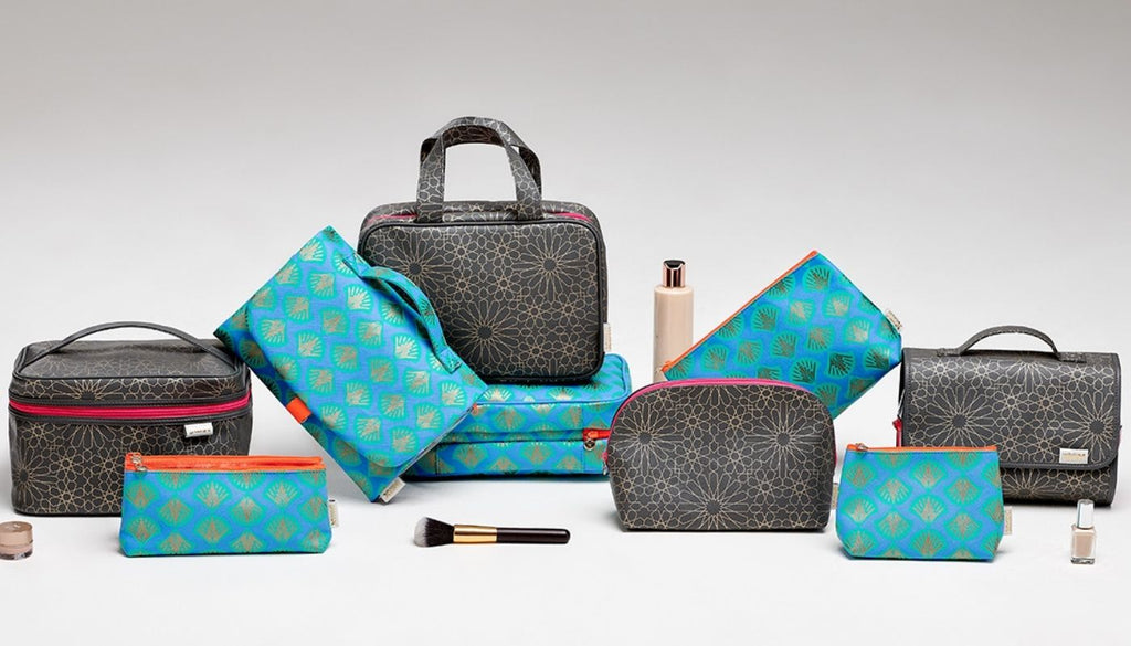 collection of wash bags and make up bags in blue and charcoal