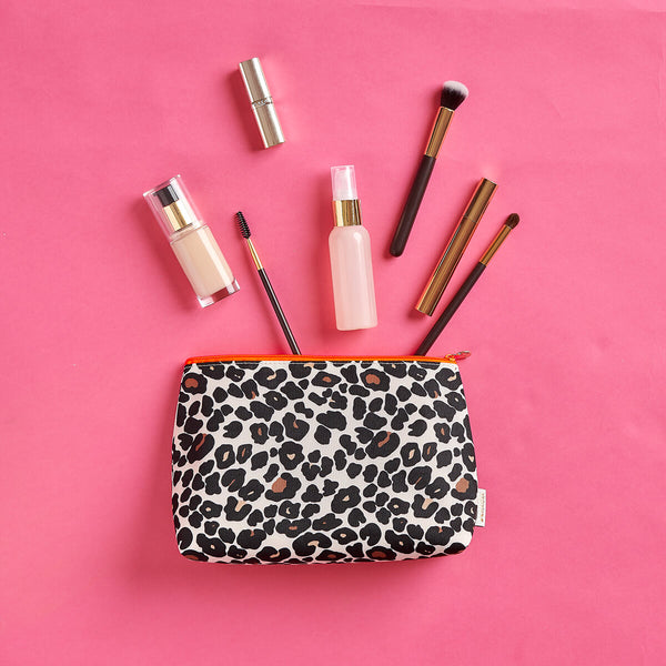 Large make up bag with make up products and brushes in leopard tan print