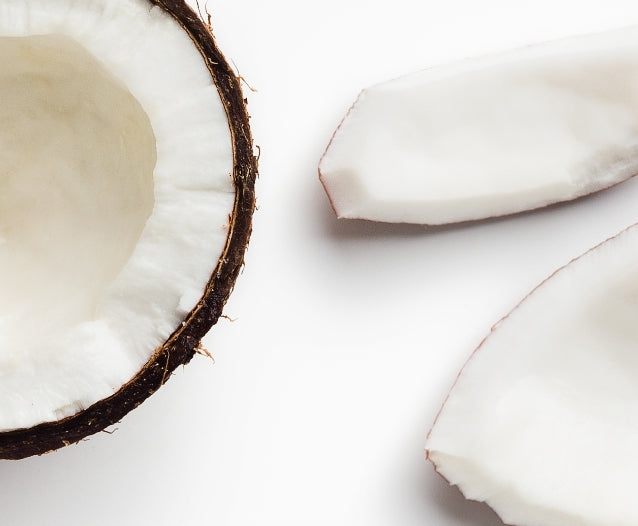 Broken pieces of coconut on a white background