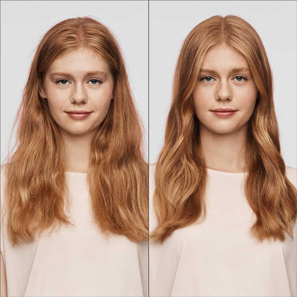 Red-haired woman with pink shirt with frizzy hair and smooth hair in front of grey background. 