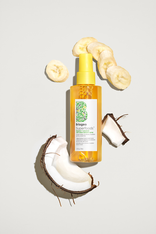 Banana + Coconut Texture Spray near pieces of banana and coconut