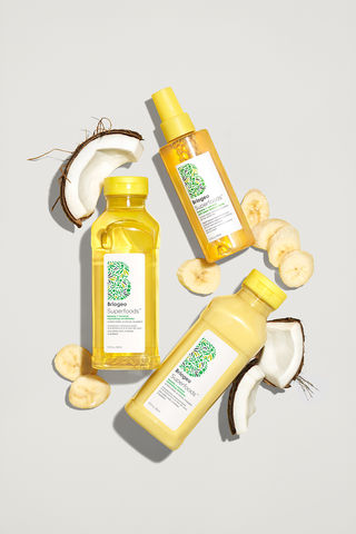 Banana + Coconut Shampoo + Conditioner near pieces of banana and coconut