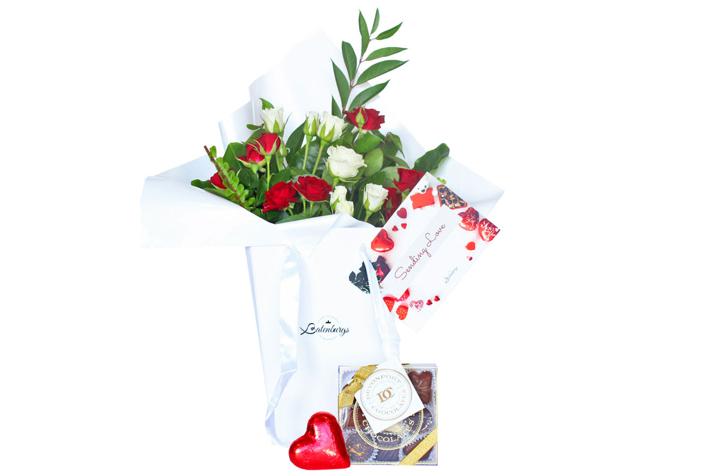 Red and white roses in a deluxe white gift bag with one chocolate heart and Devonport Chocolates luxury nine piece selection.