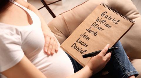 pregnant woman making list of baby names