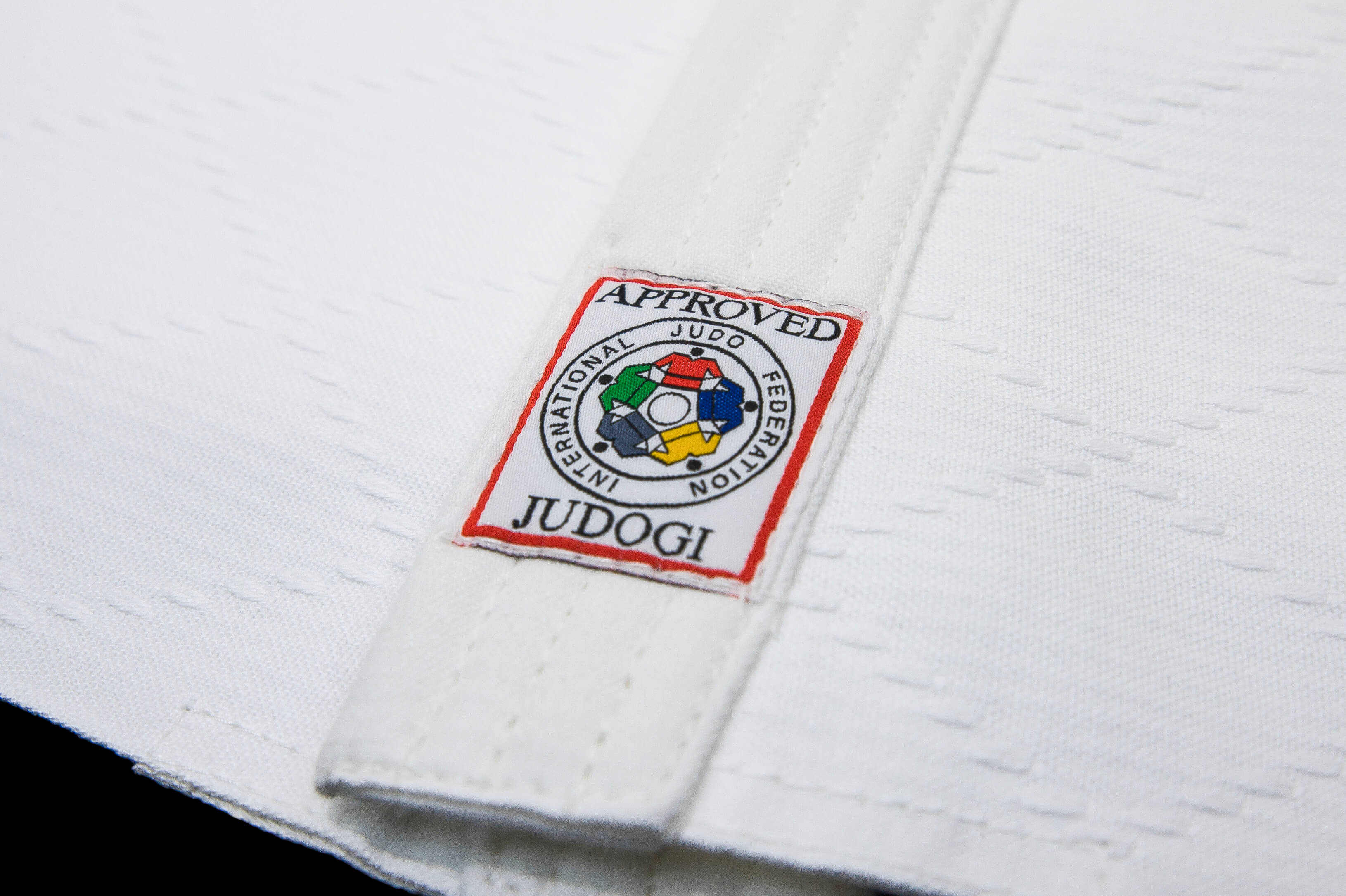 Mandatory red label on a white Judogi