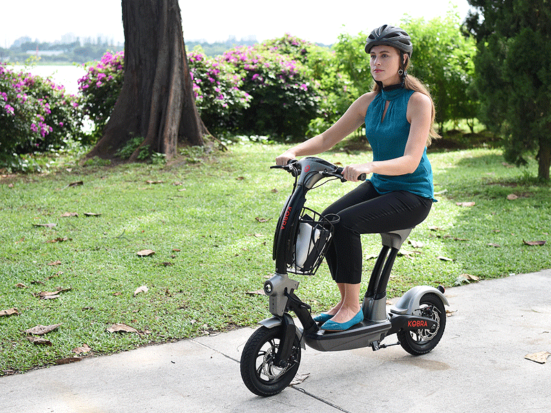 kobra seated eletric scooter with female rider