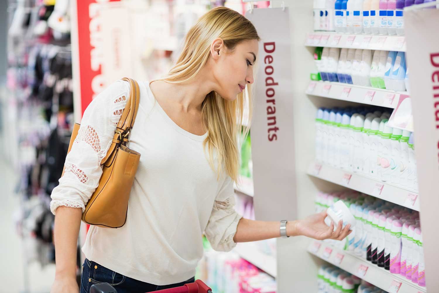 woman with long blonde hair shopping for deodorant