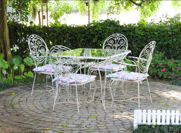 Victorian style antique table and chair in the garden