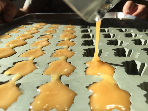 Pouring soft maple sugar candy into molds.