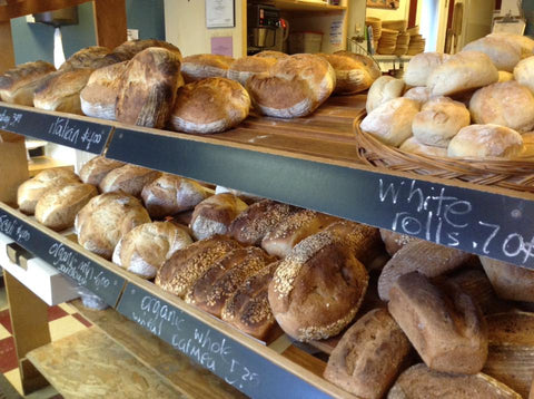 Old Village Bakery bread case featuring a range of homemade breads and rolls