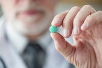 Doctor holding a pharmaceutical pill