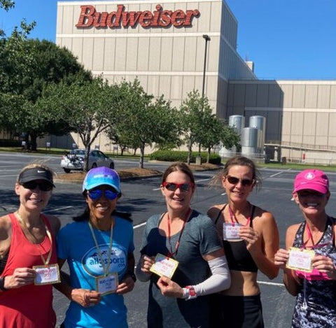 Not your traditional race finish - triathletes in a parking lot celebrating the completion of their race.