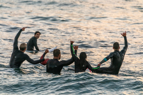 Triathletes swimming in wetsuits