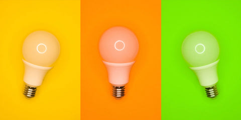 three LED light bulbs on neon colored backgrounds
