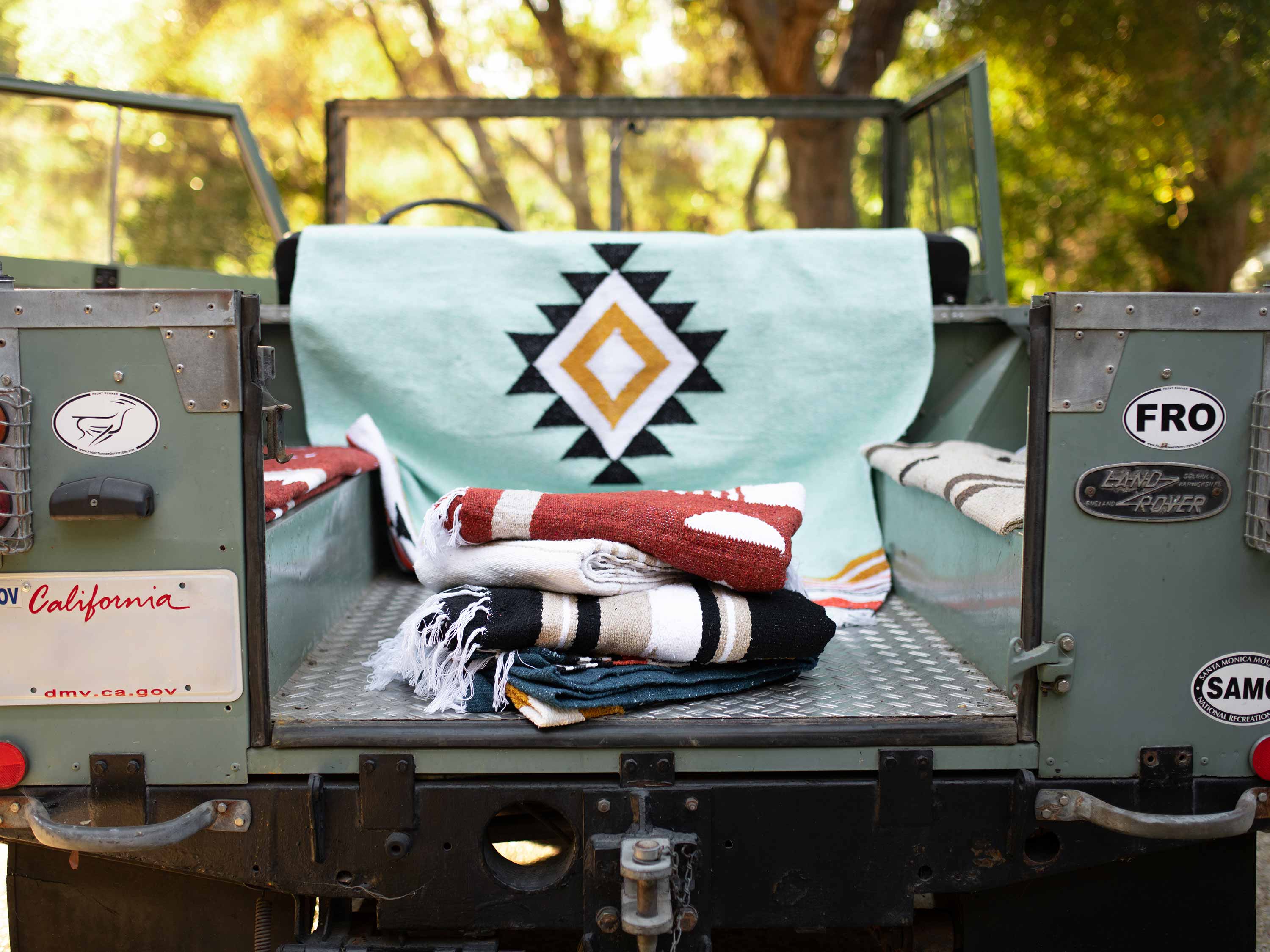 A Mexican blanket draped over a car.