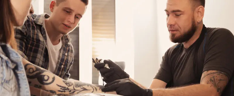 Professional Tattoo Artist Teaching an Apprentice