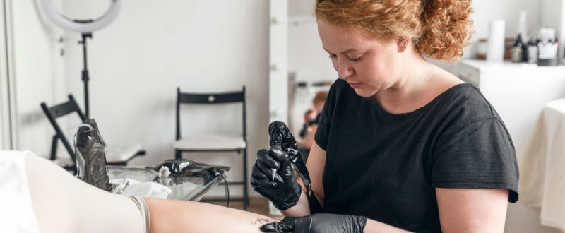a female tattoo artist doing tattoo