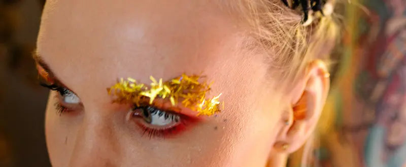 a female with glitter tattoos on her eyebrows