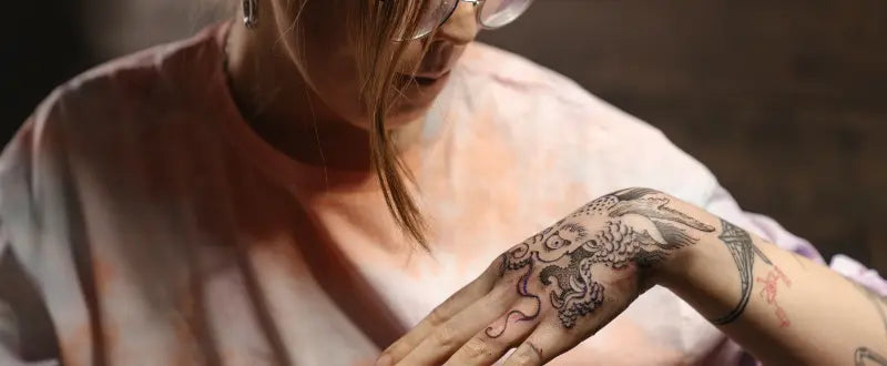 a girl with a microrealism tattoo on her hand