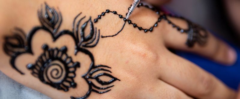 a hand with black and white tattoo