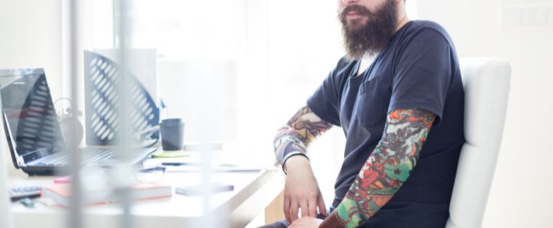 a male with full sleeve tattoo