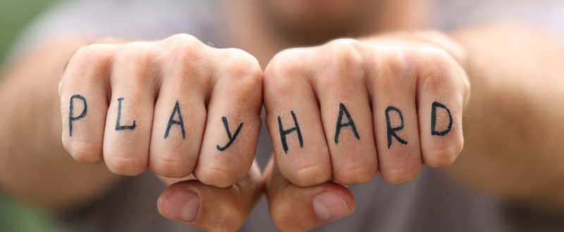 a play hard tattoo font on the fingers