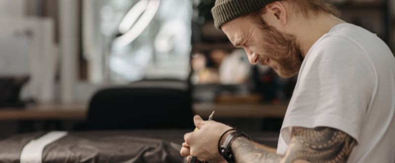an artist preparing his tattoo machine