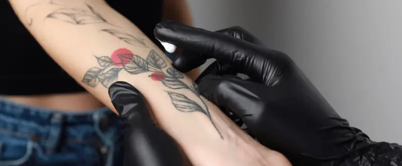 artist applying cream to the tattoo
