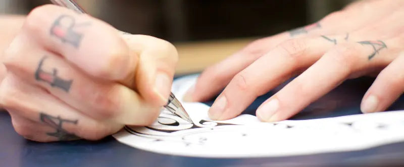 artist making tattoo stencil transfer