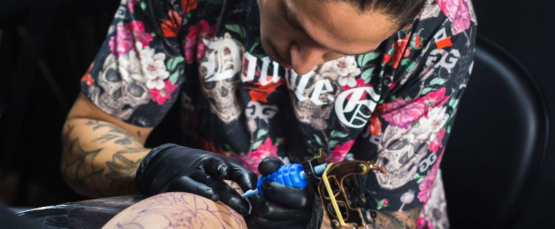 artist tattooing client