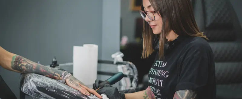 female tattoo artist doing tattoo