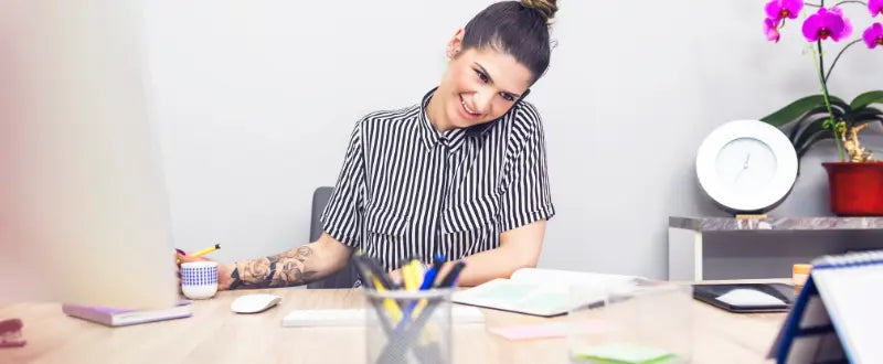 female tattoo artist having a call on her phone