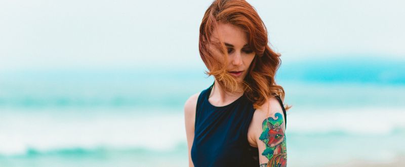 female tattoo model beside the beach