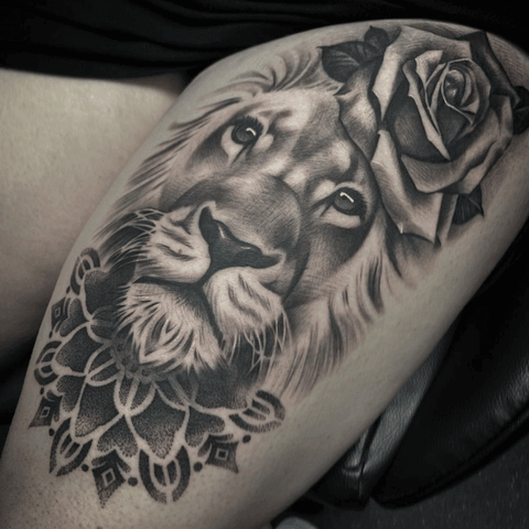 Black and grey lion tattoo