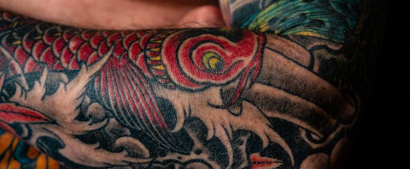 red tattoos on arm
